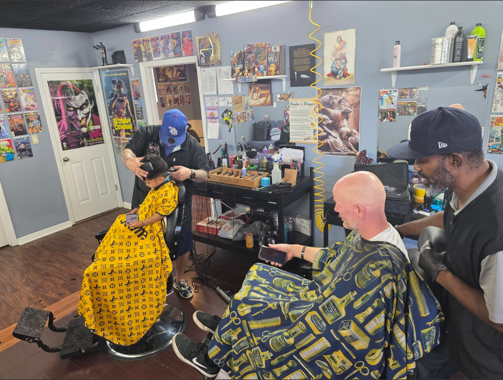 Eric and Marvin cutting hair at Heroes Only